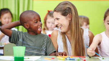 Teacher building positive relationship with student during art class