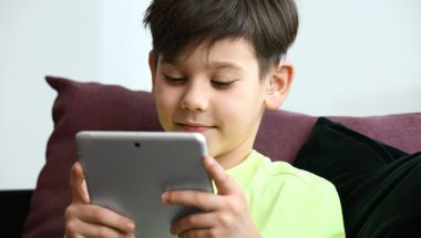 Child reading eBook on tablet
