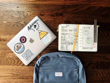 the backpack, notebook, and laptop of a student