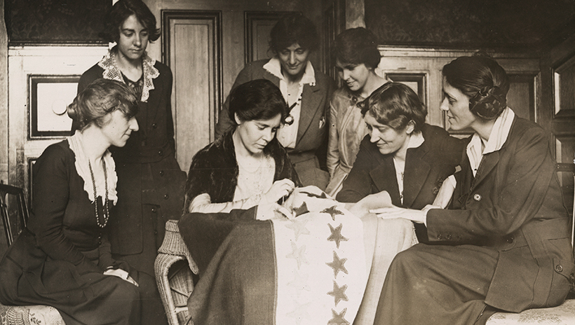 Alice Paul sews a star onto the National Woman's Party Ratification Flag after another state ratifies the Nineteenth Amendment
