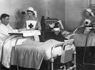 Red Cross nurses treating patients