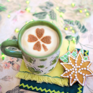 A mug of tea with a shamrock in it, with cookies
