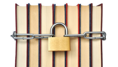 Books that are chained up with a padlock, representing banned or challenged books