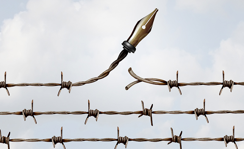 Fountain pen growing out of barbed wire