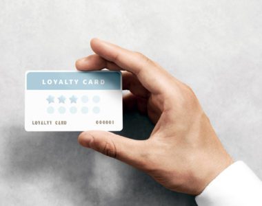 Hand with "Loyalty Card" similar to those offered by stores for discounts