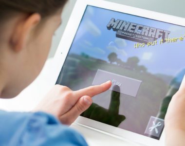 Young student playing Minecraft, which can be used as an educational game