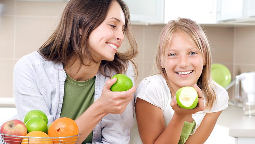 Teenager and her mother eating healthy food, as health and nutrition are an important consideration for teens' health