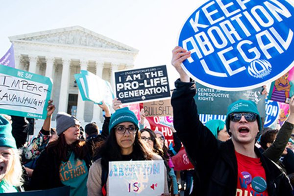 Pro-choice and pro-life activists protest outside the U.S. Supreme Court as it hears oral arguments in a case involving a Louisiana abortion law in March 2020.