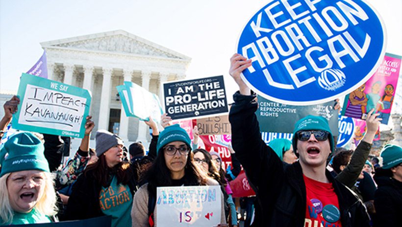 Pro-choice and pro-life activists protest outside the U.S. Supreme Court as it hears oral arguments in a case involving a Louisiana abortion law in March 2020.
