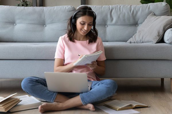 Student engaged in online learning in her living room