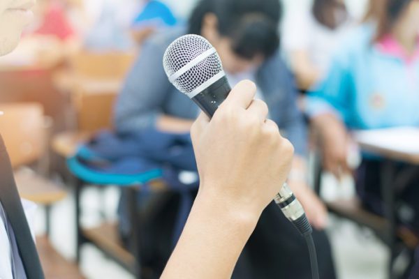 Student with microphone at class debate