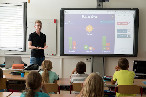 Teacher using visual multimedia in front of classroom