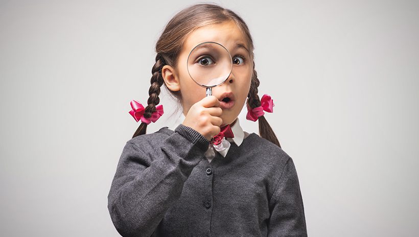 Elementary school girl with magnifying glass