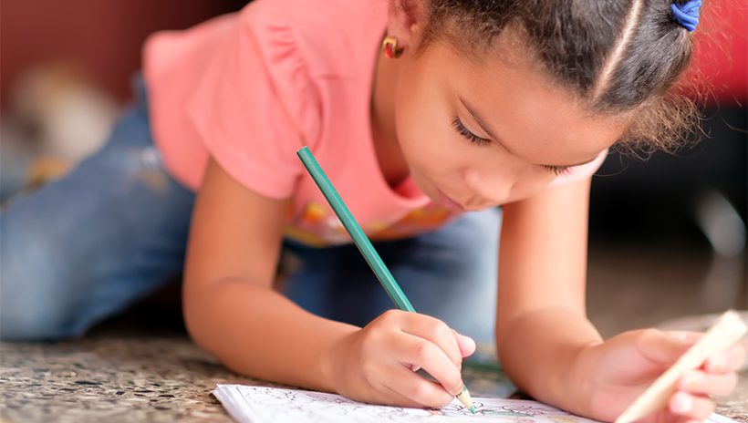 Little girl writing in journal