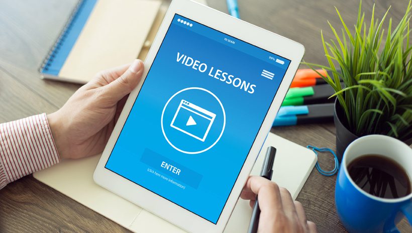 Tablet with "VIDEO LESSONS" on the screen