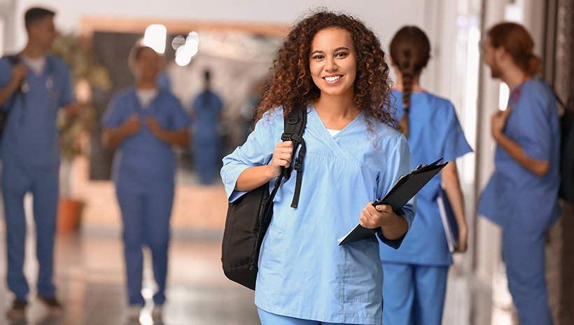 Health care student in care facility training program walking down hallway